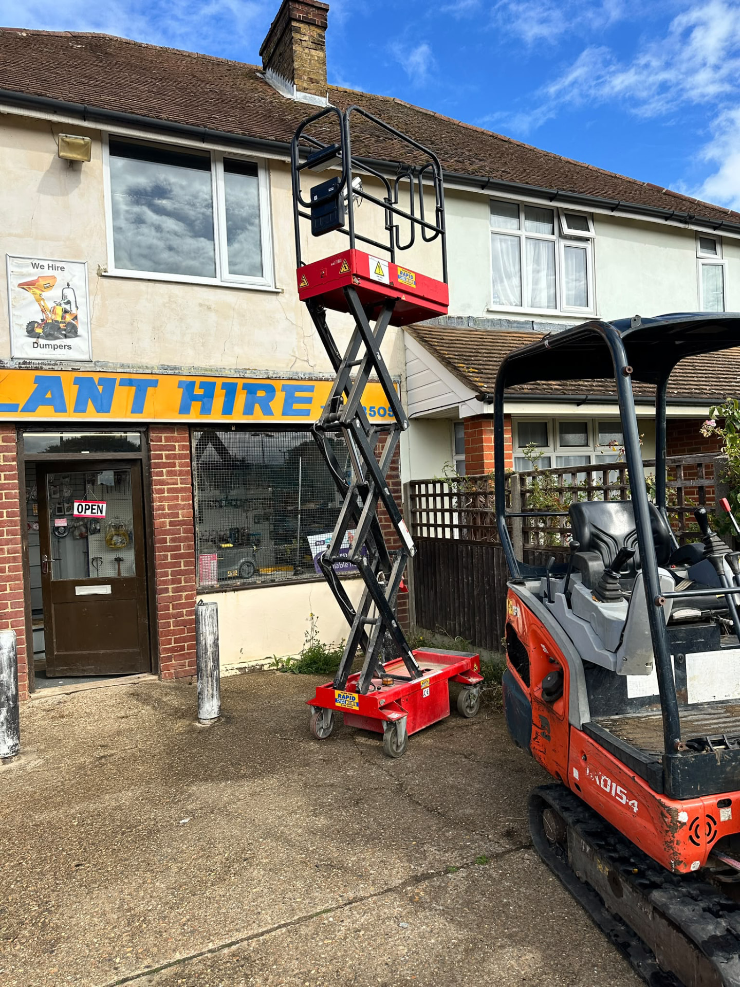 Rapid Plant & Tool Hire shopfront in Sittingbourne with scissor lift and mini digger